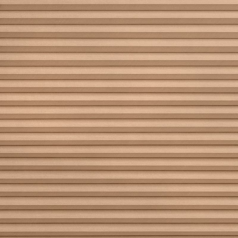 Tan pleated fabric blinds, tightly closed with evenly spaced horizontal folds, blocking the view and diffusing light, filling the frame against a neutral interior with soft, even lighting.