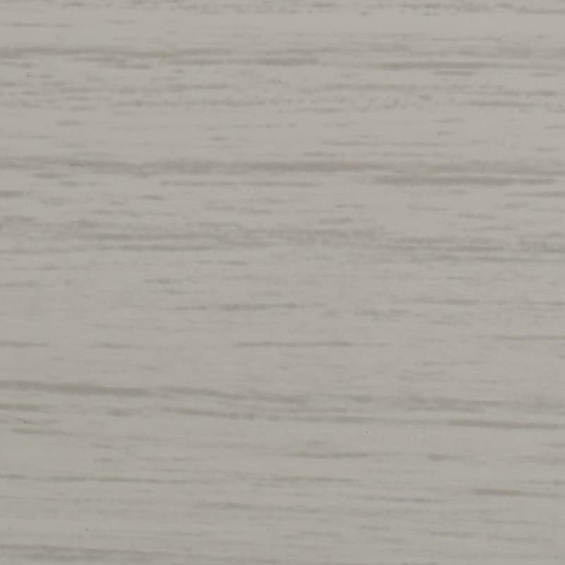 Light gray wood-grain panel with subtle horizontal streaks; lying flat and static, showing fine texture; close-up view of an evenly lit interior surface resembling laminate wall or tabletop.
