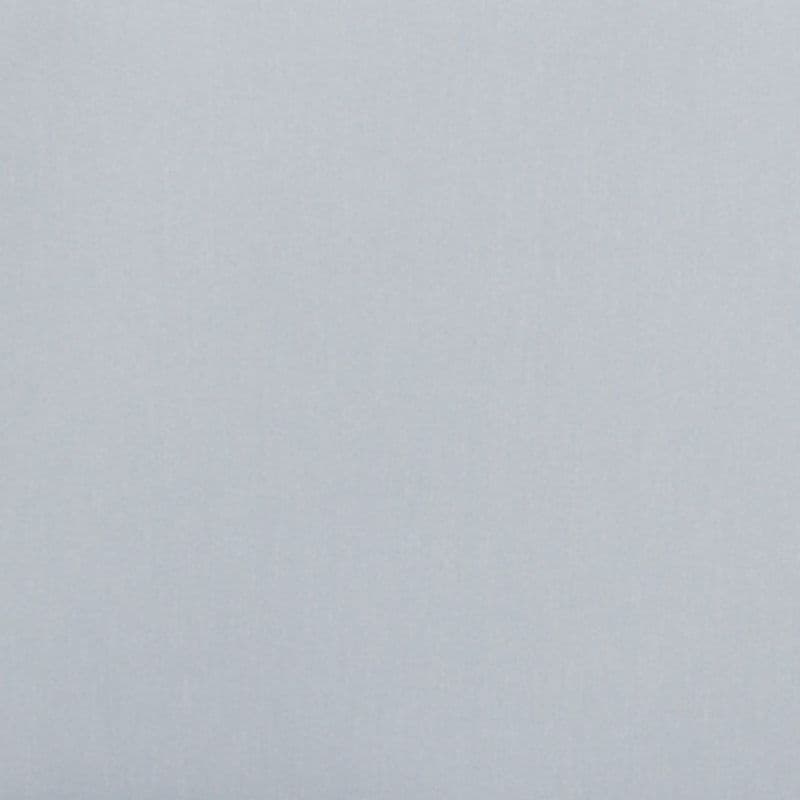 Plain pale-gray textured surface (wall or paper) showing faint vertical grain, occupying the entire frame, evenly lit with soft diffuse light, no other objects or features visible.