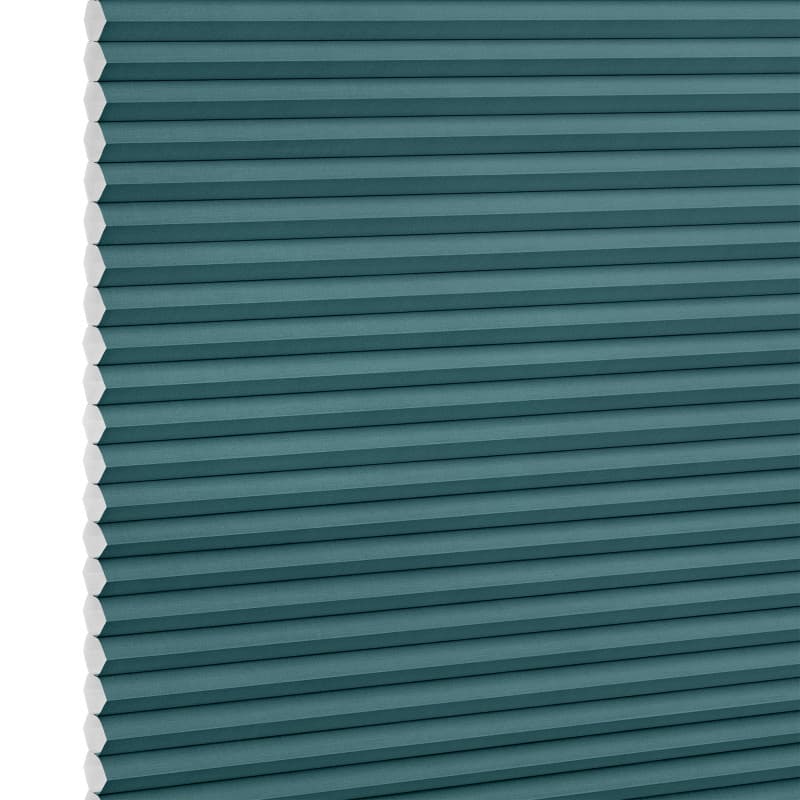 Teal honeycomb (cellular) blind, fully lowered with visible white hexagonal cell edges, closed over a window; minimalist product-style setting with even, neutral lighting.