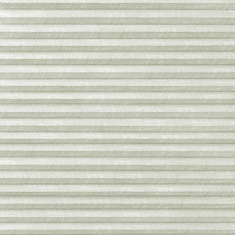 Horizontal pleated cellular blinds (pale sage, textured), closed and filtering diffuse daylight, covering a window in a softly lit interior, showing uniform horizontal folds and a subtle woven pattern.
