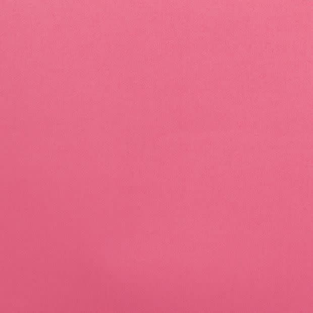 Solid pink textured fabric fills the frame, lying flat and evenly lit; no other objects or features are visible, producing a uniform matte backdrop with subtle weave texture.