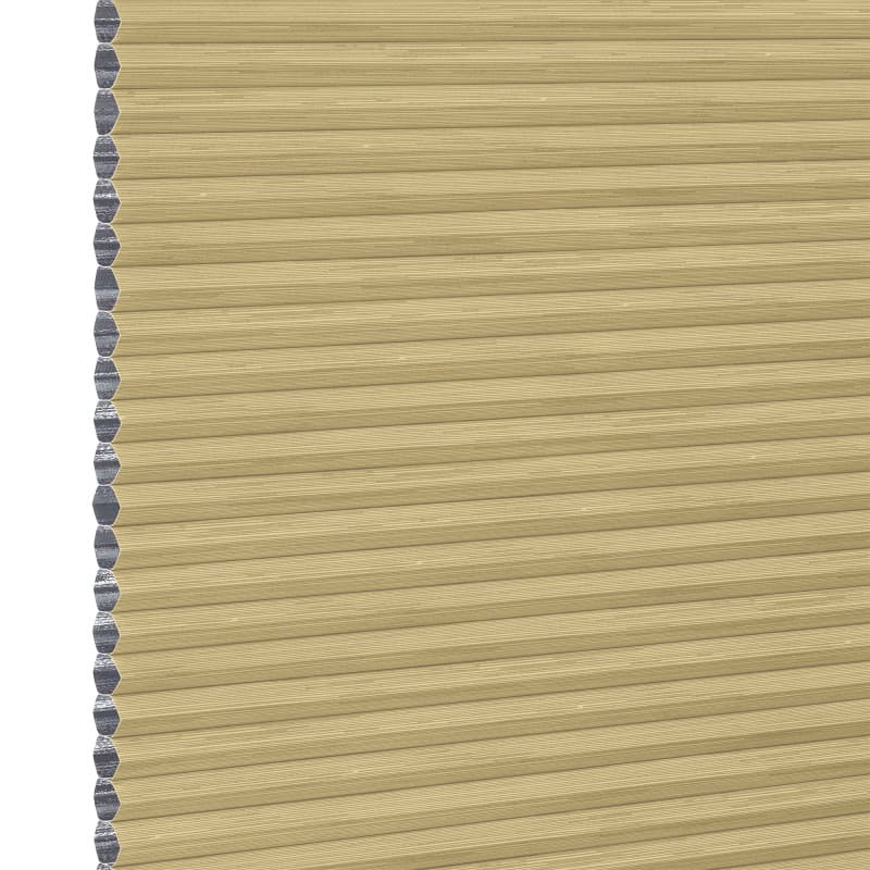 Honeycomb (cellular) blind, tan with silver inner cells, fully lowered and closed, filtering and blocking light; close-up view showing horizontal pleats and cell edges against a neutral interior background.