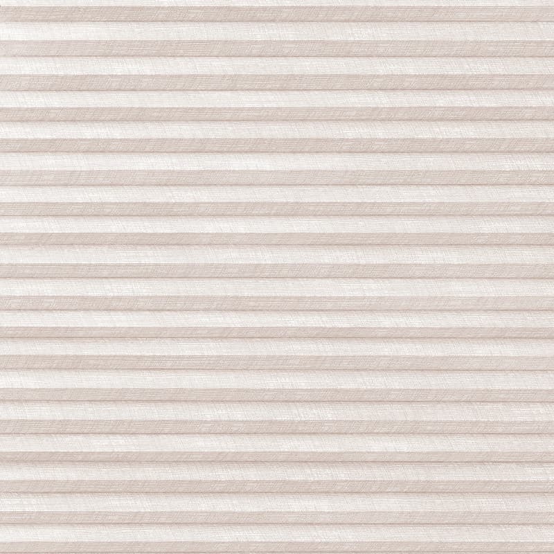 Beige pleated cellular blind, horizontal accordion folds with linen texture, fully lowered and closed, softly diffusing daylight across a neutral interior wall.