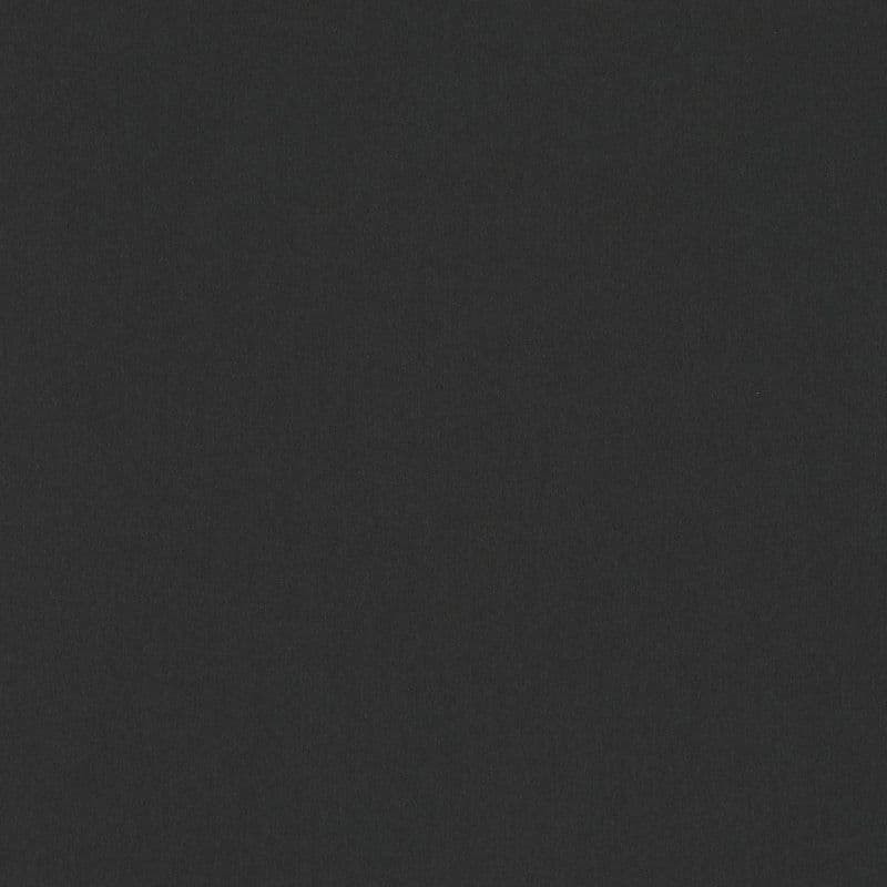 Matte black, grainy fabric-like surface fills the frame, lying flat and static, evenly lit with subtle noise texture and no discernible surroundings.