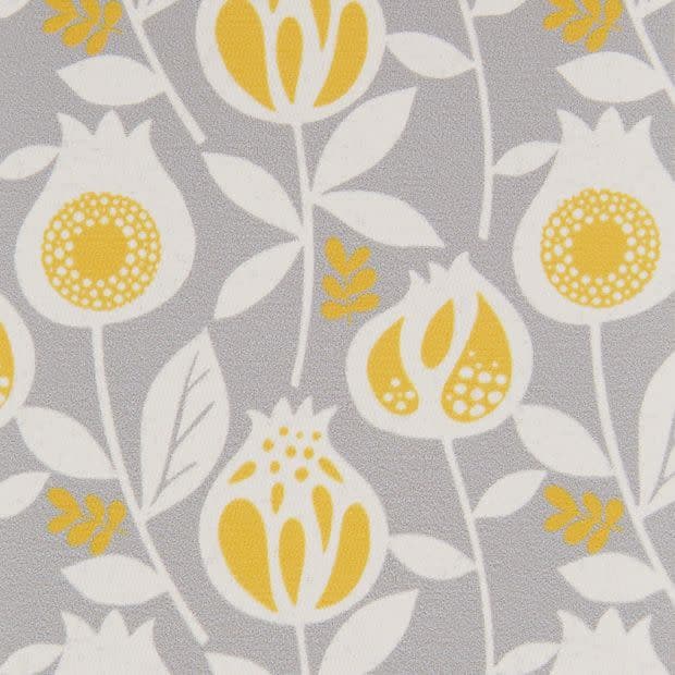 Decorative fabric or wallpaper with stylized yellow-and-white floral motifs â€” repeating pattern across the surface â€” flat close-up, evenly lit, light-gray background.