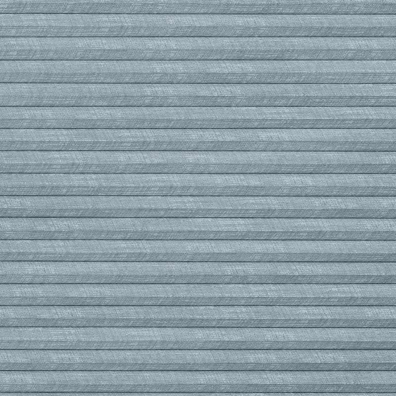 Horizontal pleated cellular blind, light-blue textured fabric with subtle cross-hatch pattern; fully closed, forming even horizontal folds; interior setting with soft, diffused light and no visible outside view.