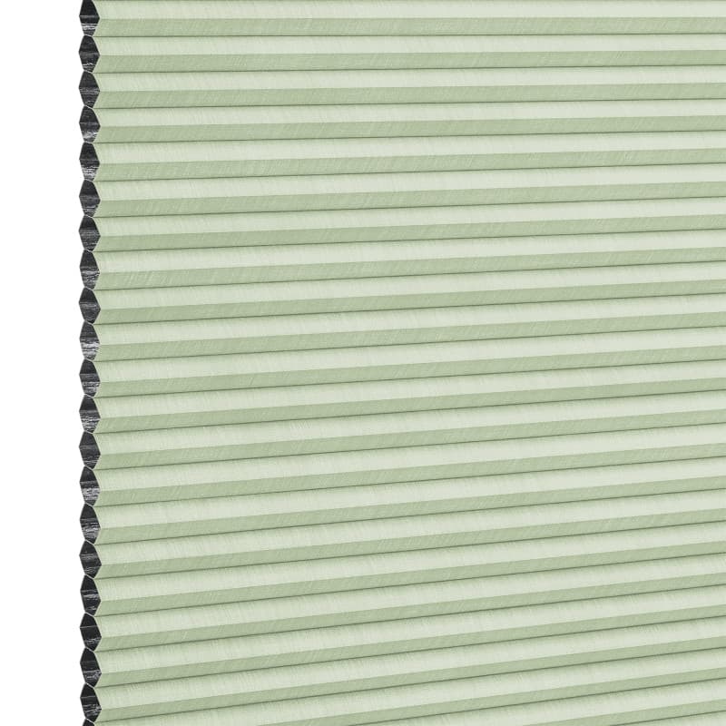 Cellular (honeycomb) blind, pale green with visible black cell edges â€” closed, pleated and covering the frame â€” close-up product view with even lighting and a neutral background.