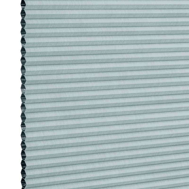 Light teal cellular (honeycomb) blind, fully lowered with visible hexagonal cells at left edge; horizontal pleats create uniform bands, blocking light in a close-up, evenly lit neutral background.