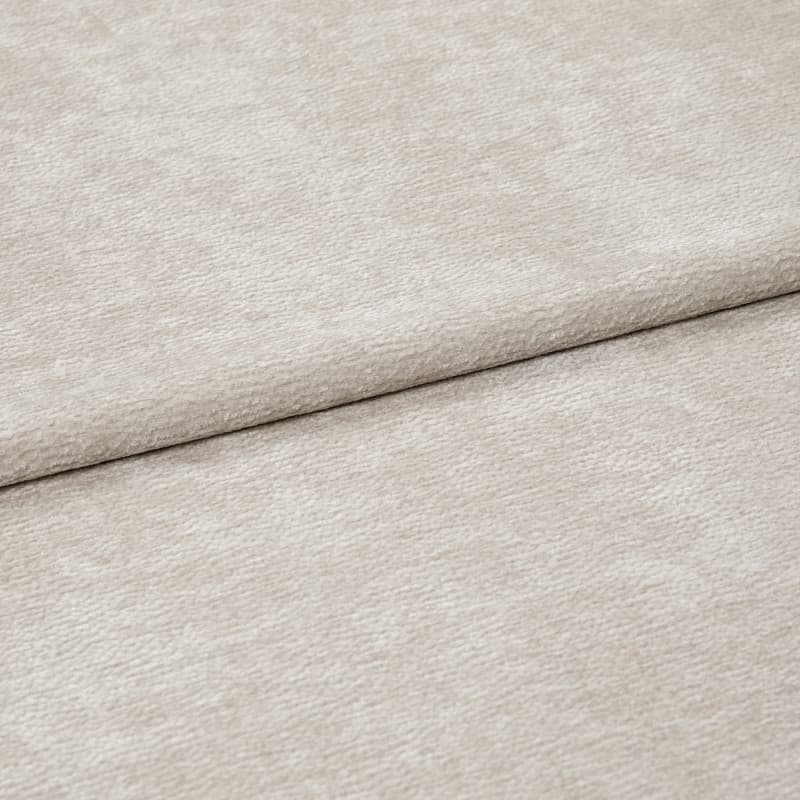 Beige textured fabric, folded with a horizontal overlap; soft, slightly napped surface; close-up, evenly lit view of neutral upholstery or drapery textile.