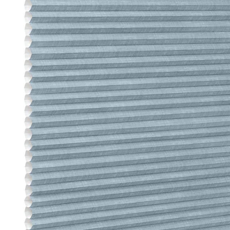 Light-blue cellular (honeycomb) shade, pleated horizontal cells with white interior along left edge; fully lowered and closed, blocking light; shown as product against a plain white background.