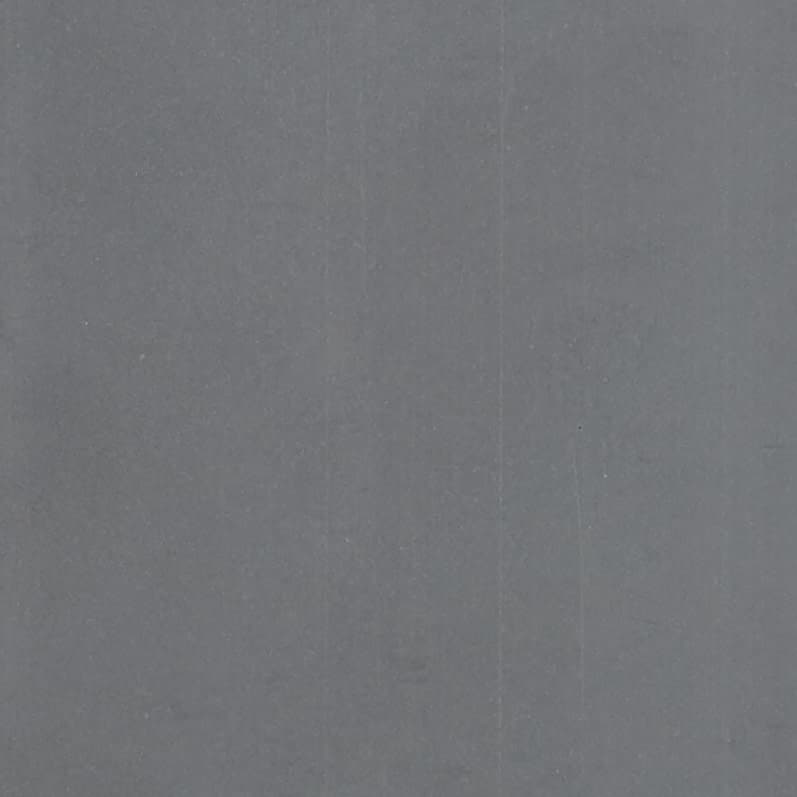 Plain gray surface (fabric or paper) with faint vertical creases and light speckling; filling the frame, static; evenly lit close-up, neutral background.