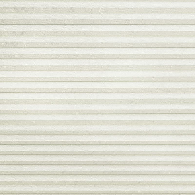 Cream-colored cellular (honeycomb) blind with narrow horizontal pleats, fully lowered and closed, gently filtering diffuse daylight while covering the entire window area in a neutral indoor setting.