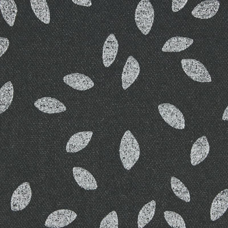Dark charcoal woven fabric patterned with scattered white, textured leaf-shaped ovals; motifs roughly evenly spaced, creating a repeating decorative design; close-up, flat diffuse lighting and no visible surroundings.