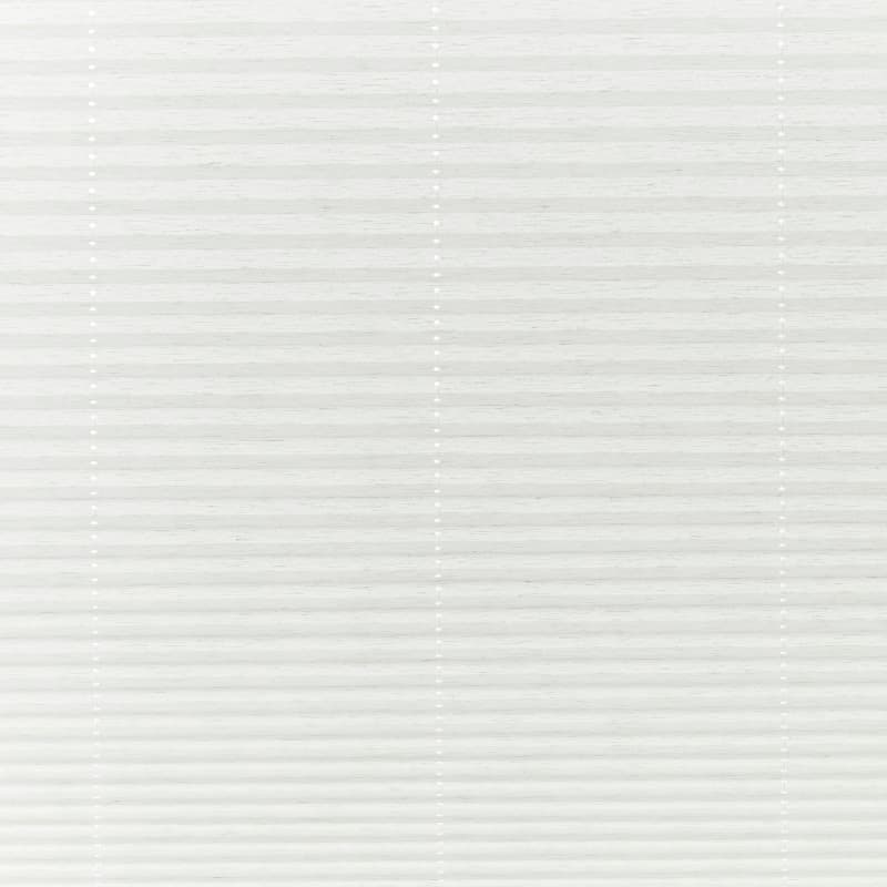 White pleated cellular blinds, fully lowered across the window with three vertical beaded cord ladders, closed and diffusing soft daylight into a neutral, minimally furnished interior.