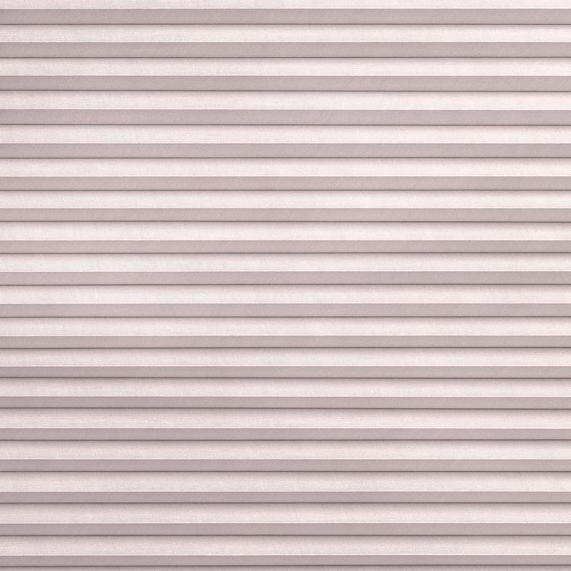 Pleated fabric blinds, horizontal pleated folds, fully closed, gently diffusing soft daylight; mounted over a window in a neutral-toned interior, creating uniform, muted light and textured pattern.