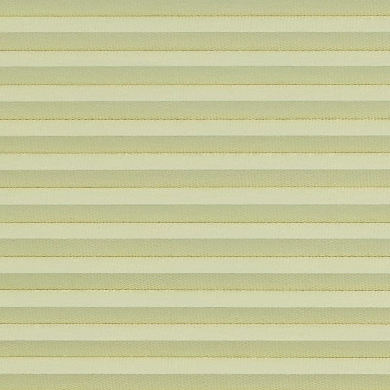 Honeycomb cellular blind with horizontal pleats, fully lowered and closed, diffusing soft daylight; close-up interior view showing uniform pale-yellow bands filling the frame.