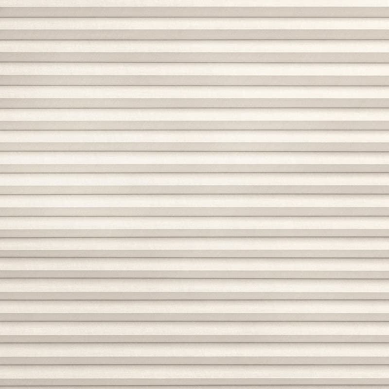 Horizontal pleated fabric blind, fully lowered and tightly closed with even ridges and beige texture; gently filtering soft daylight; fills a window opening in a neutral, softly lit interior.