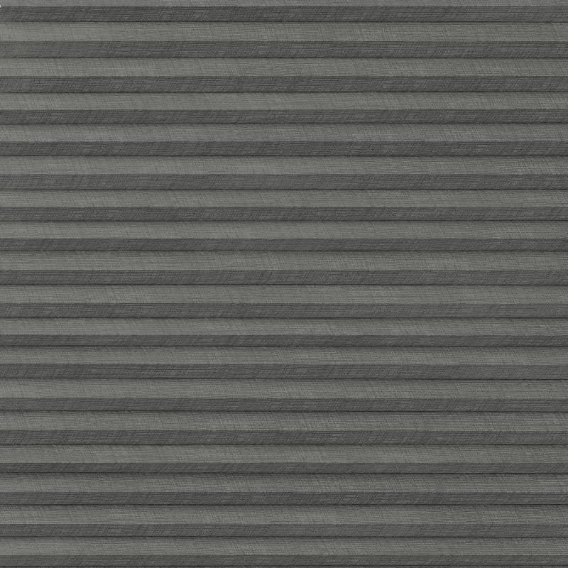 Gray pleated fabric blind with horizontal accordion folds â€” closed and blocking light â€” fills the window frame, evenly lit interior, no visible view or furnishings.