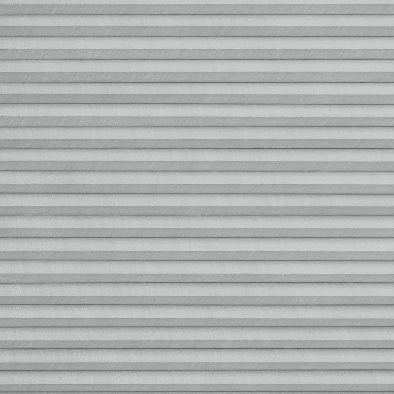 Gray pleated cellular blinds, fully lowered with horizontal fabric cells and subtle texture; closed and filtering diffuse daylight; covering an interior window in a softly lit room, no view visible.