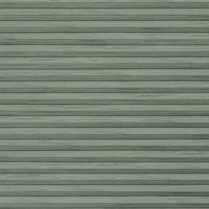 Pale-green horizontal metal rolling shutter with narrow ribbed slats dominates frame; fully closed, slightly weathered; exterior storefront or garage faÃ§ade under even daylight.