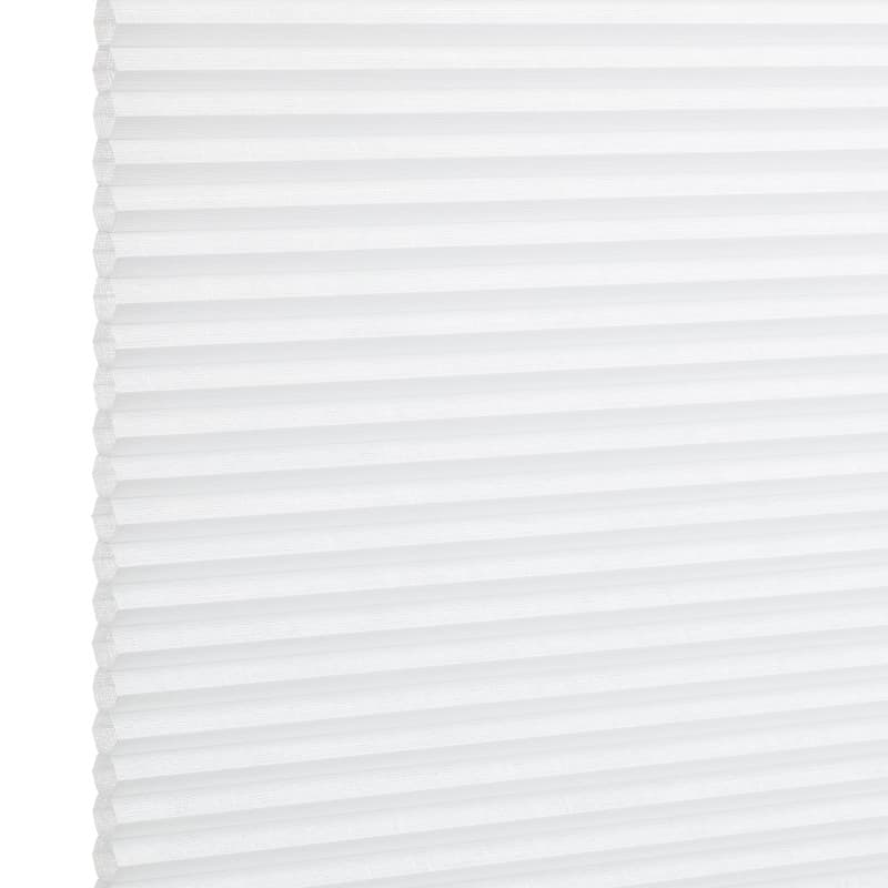 White pleated cellular window shade, fully lowered and closed with regular horizontal honeycomb cells; filtering diffuse light in a bright, minimal interior setting.