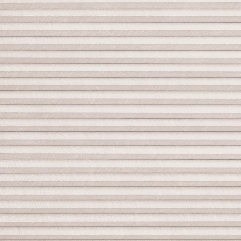 Beige textured pleated cellular blind, fully lowered and closed with horizontal folds; filtering soft, diffused daylight and obscuring the outside in a neutral interior setting.