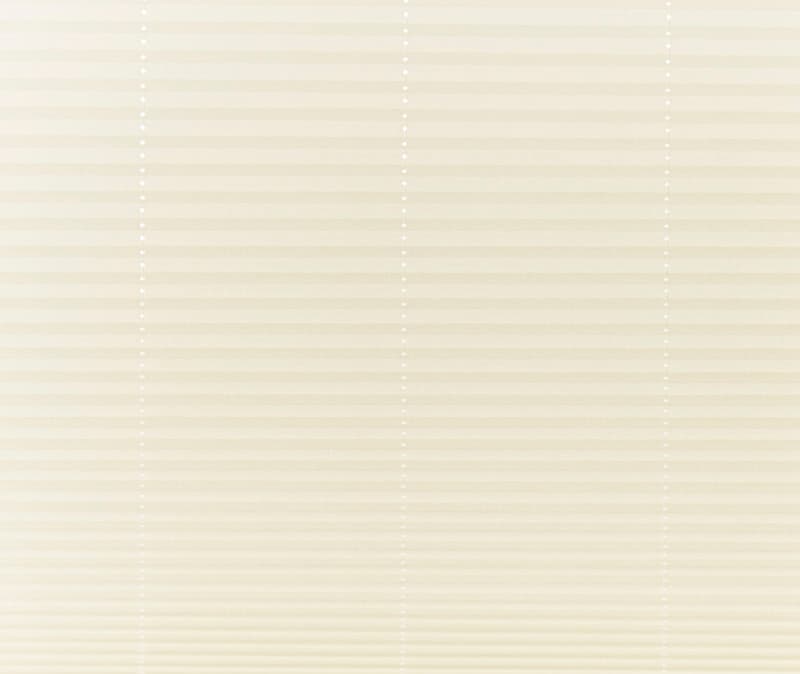 Beige pleated cellular shades covering a window, fully lowered and closed with vertical bead cords visible; filtering soft, diffused daylight into a neutral-toned interior, obscuring any outside view.