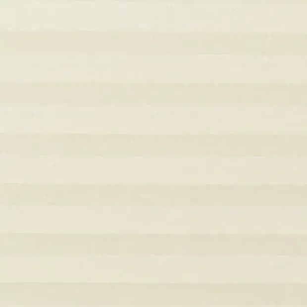 Cream pleated cellular blind covering a window, fully lowered and closed with soft horizontal bands; gently diffusing daylight into a neutral, evenly lit interior.