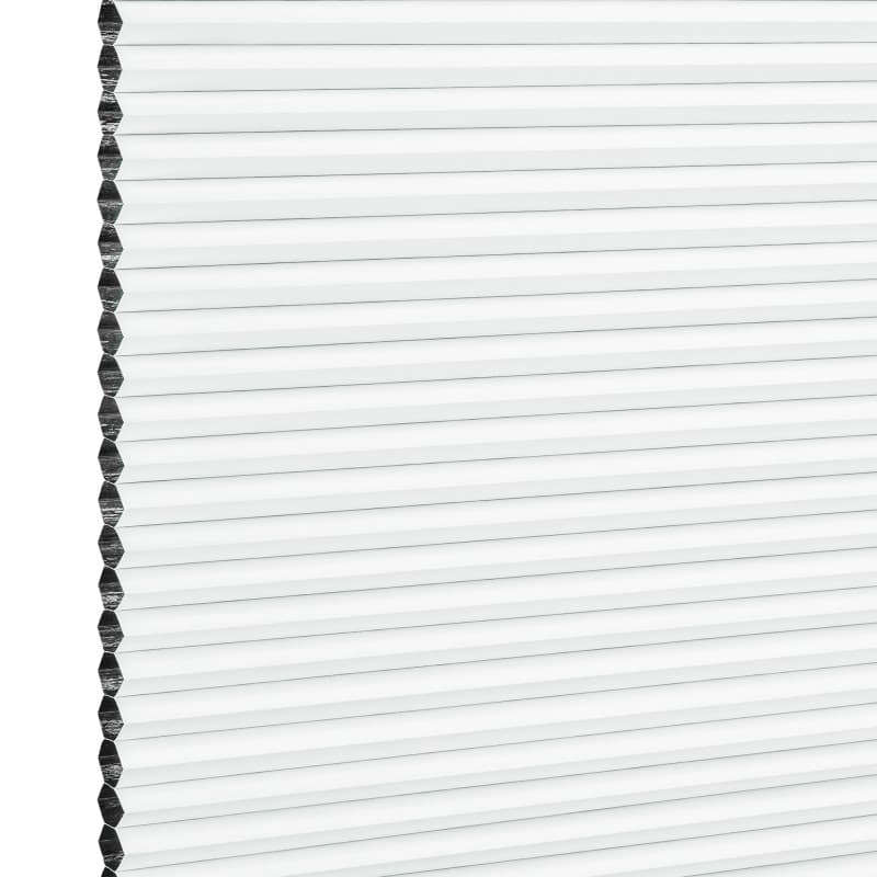 White honeycomb (cellular) window blind with visible hexagonal edge, fully lowered and closed, diffusing bright daylight and covering the window; simple, evenly lit background, no room details.