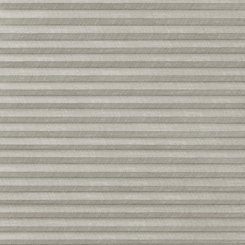 Pleated cellular window shade, light-gray textured fabric; fully lowered and closed, forming horizontal ridges; filtering diffuse interior light and obscuring any outside view.