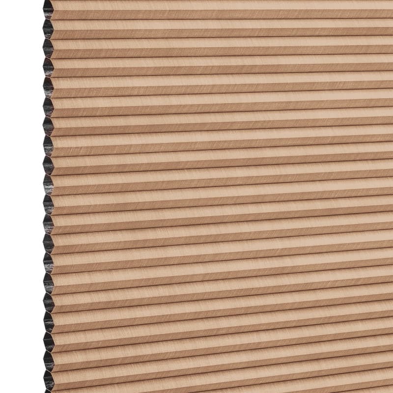Beige honeycomb cellular blind with horizontal pleats, closed and compacted, honeycomb cells visible at the left edge; studio-lit product view against a white background.