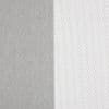 Two curtain panels—left opaque gray, right white sheer with small rectangular mesh—hang side-by-side, the sheer diffusing light while the opaque blocks it; close-up interior view.