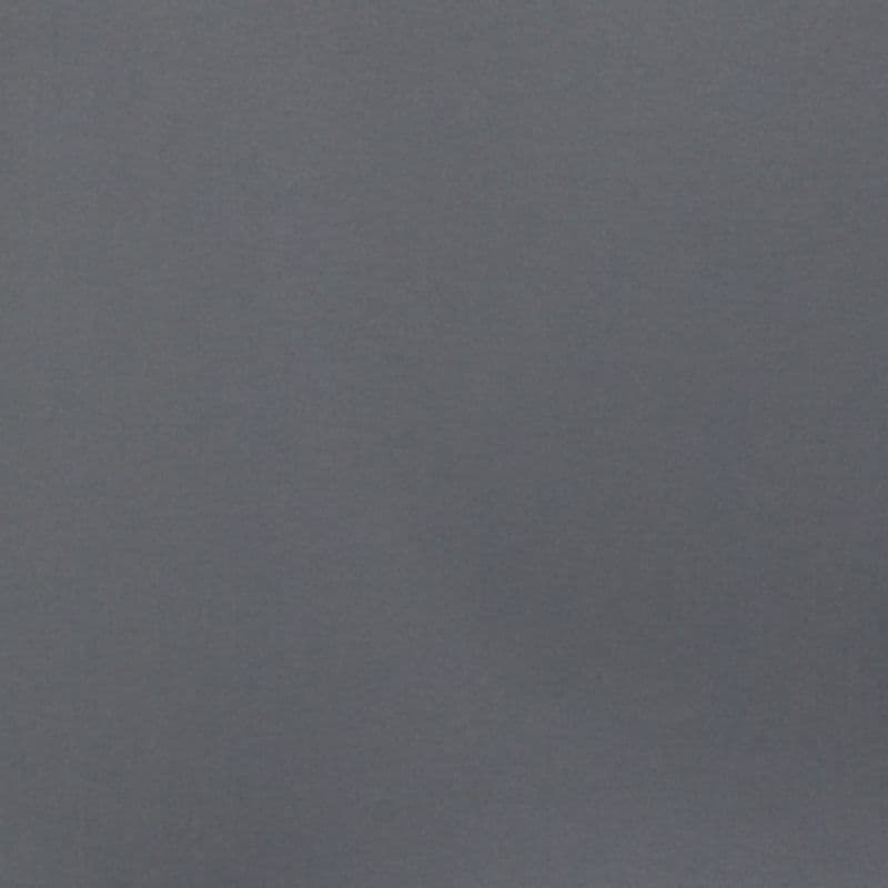 Smooth matte gray wall filling the frame, unadorned and uniformly lit; appearing static and featureless, suggesting a minimally furnished interior with soft, diffuse ambient lighting.