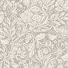 Beige wallpaper with cream, distressed botanical print—stylized leaves, flowers, seed pods and small birds—decorating a surface; close-up view with even, neutral lighting.
