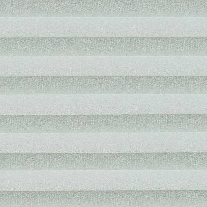 Cellular pleated blinds, fully lowered with evenly spaced pale gray-green horizontal bands, filtering diffuse daylight across a neutral interior and creating soft, uniform illumination.