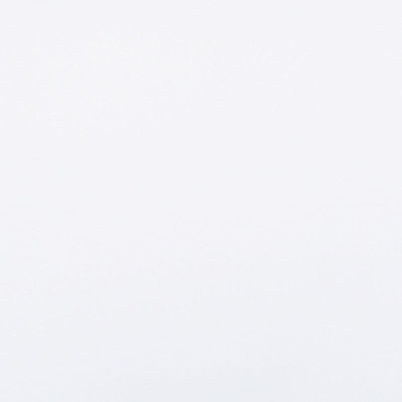 Plain white textured surface (wall or paper) filling the frame, evenly lit and featureless, creating a minimal, diffuse-light background with no discernible objects or shadows.