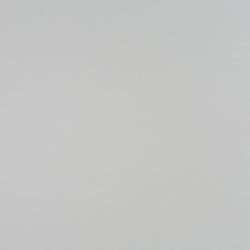 Light-gray textured wall — unadorned, uniform surface filling the frame; lying flat and featureless, illuminated by soft diffuse lighting, with no visible furniture, windows, or other context.