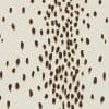 Cream fabric patterned with irregular brown brushstroke ovals — clustered centrally and scattered outward — covering a flat surface under even, neutral lighting, resembling abstract textile or wallpaper.
