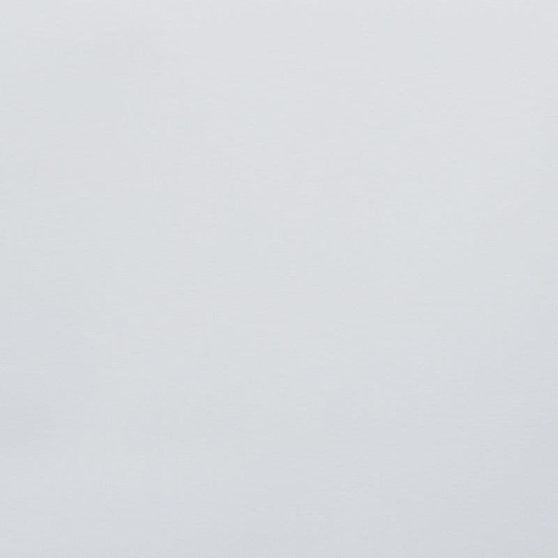 Plain pale-gray wall occupying the frame, unadorned and uniformly lit, showing subtle fabric-like texture; minimal context with soft diffuse light and no visible furnishings or details.