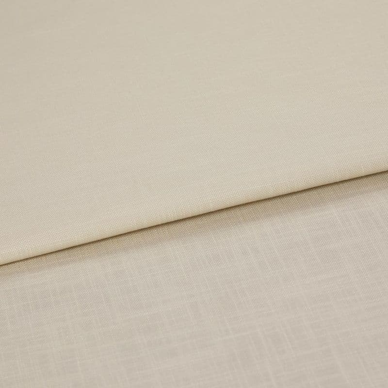 Beige woven fabric panels folded over one another, overlapping to reveal two subtle textures; shown in a close-up with even, neutral lighting on a flat surface.