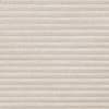 Beige pleated cellular blind covering entire frame, fully lowered and closed with horizontal folds; filtering soft diffuse indoor light against a textured fabric surface.