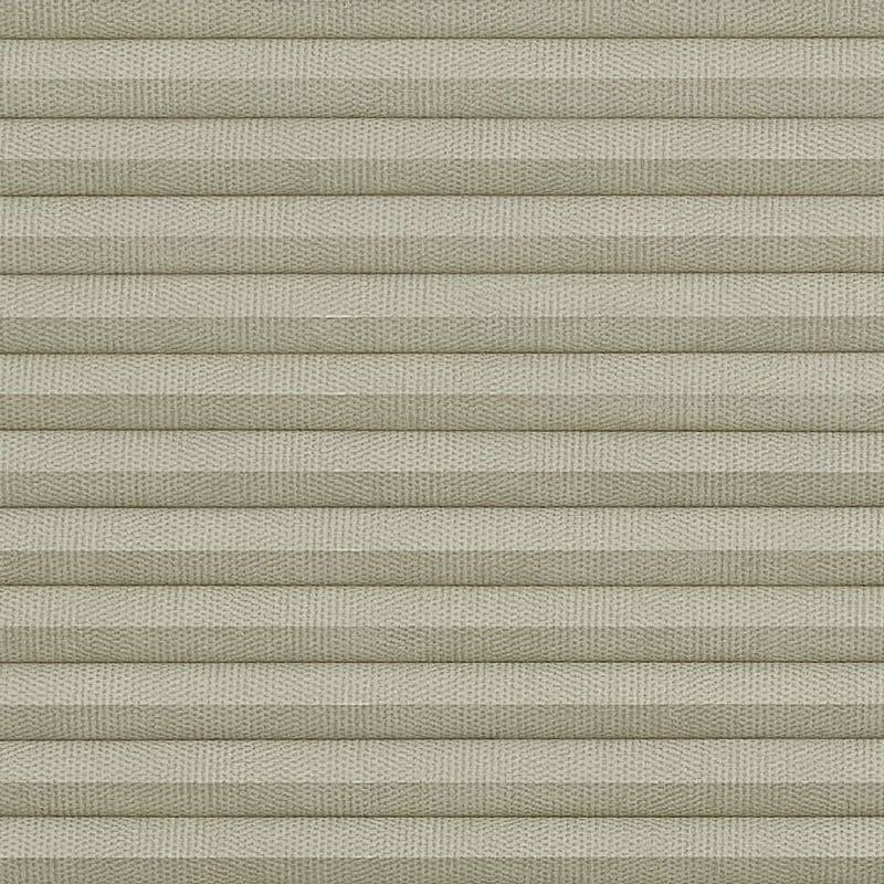 Beige pleated cellular fabric blind, horizontal folded slats with woven texture, fully closed and blocking light; close-up view with soft, even lighting, no visible window or room.