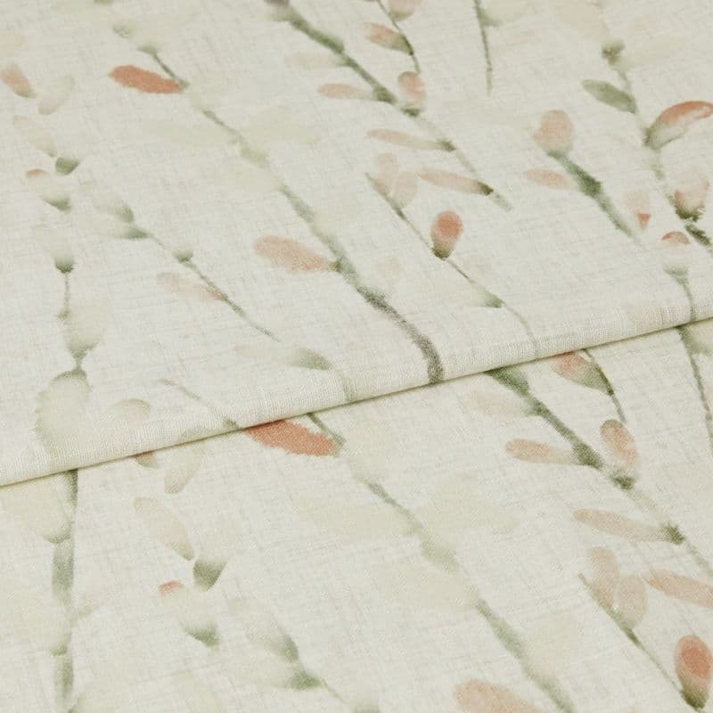 Cream linen-look curtain fabric with soft green stems and peach buds, folded across the frame, overlapping at the center; close-up view with gentle, diffuse lighting showing woven texture.