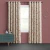 Floral grommet curtains (cream with pink‑beige leaves) hang on a rod, parted to frame a window; set against mauve walls with a teal dresser and circular sconce, lawn visible outside.