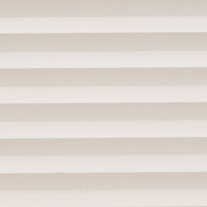 Horizontal cellular blinds with alternating beige and off-white pleats, closed and filtering soft daylight; they cover a window within a neutral interior, producing even, diffuse light and no view.