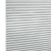 Light-gray pleated cellular blind with horizontal honeycomb folds, fully lowered and closed, filtering diffuse light in a neutral, softly lit interior; close-up view.