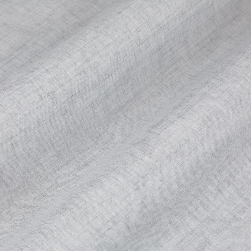 Light gray woven linen curtain, hanging in gentle horizontal folds with visible cross-weave texture; filtering soft, diffuse daylight in a neutral, close-up interior view (no visible window or room features).