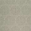 Textured wallpaper with overlapping concentric circular mosaic patterns in muted beige, green, and gray, repeating across and covering the entire surface, on a flat interior wall under soft, even light.