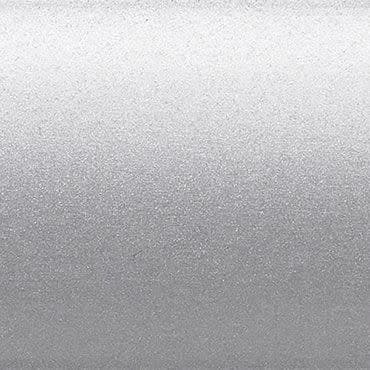 Silver metallic textured surface occupying the frame, scattering diffuse light with a subtle horizontal gradient; a flat, finely granulated panel in a neutral, evenly lit background.